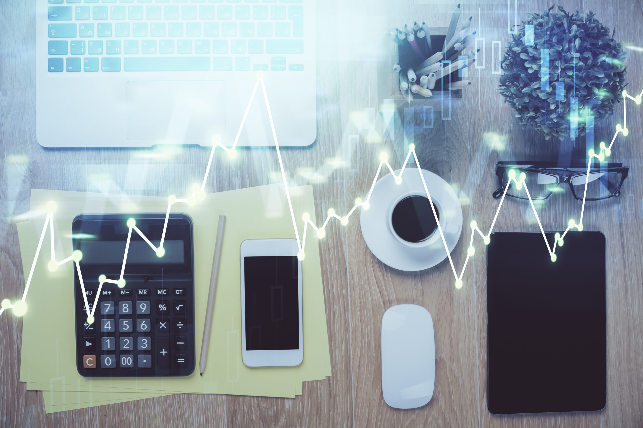 Double exposure of forex chart hologram over desktop with phone. Top view. Mobile trade platform concept.