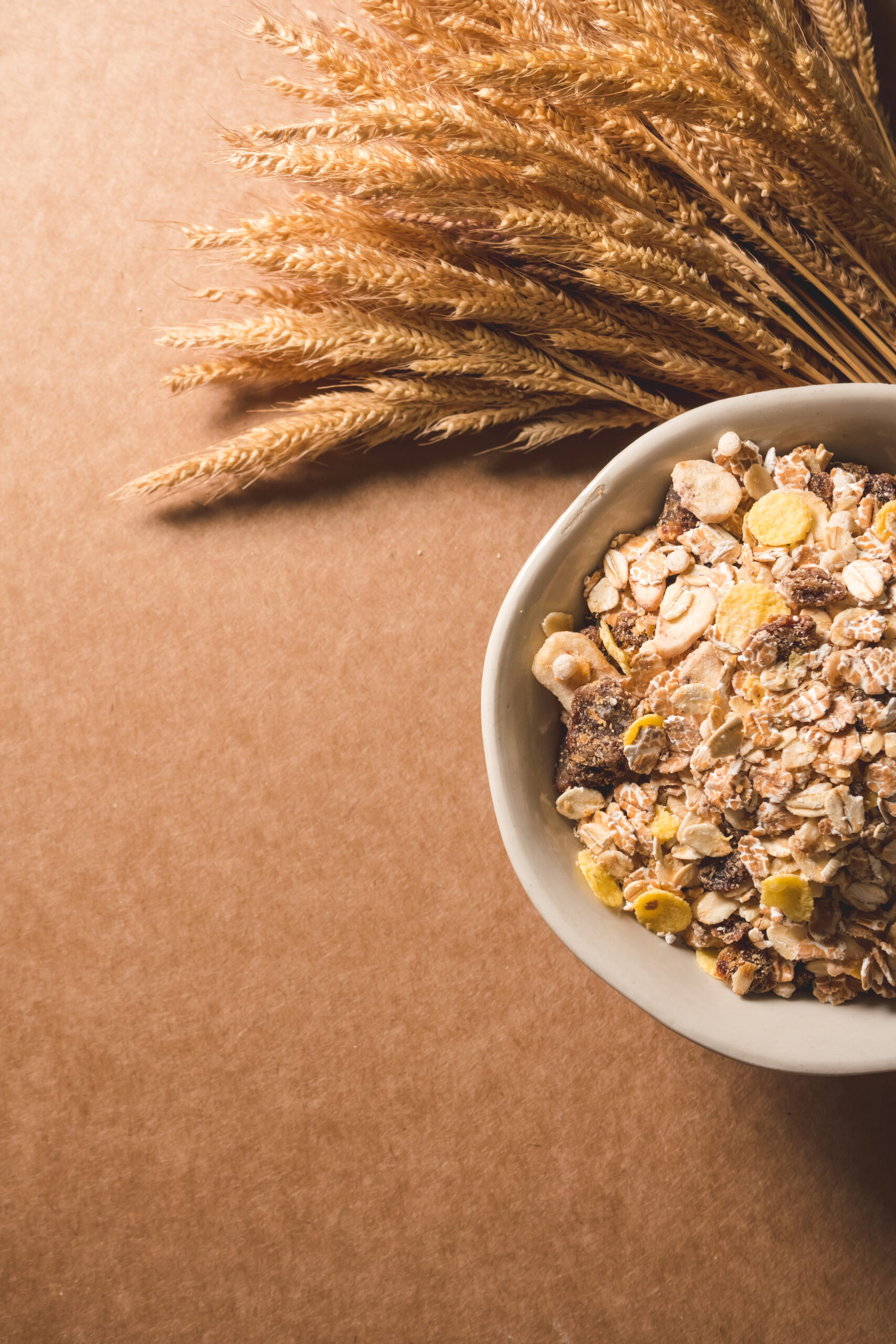 Top view of oatmeal flakes in a bowl on wooden table. Healthy breakfast concept. copy space