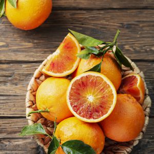 Sweet red oranges of Sicily in the basket, rustic style and selective focus