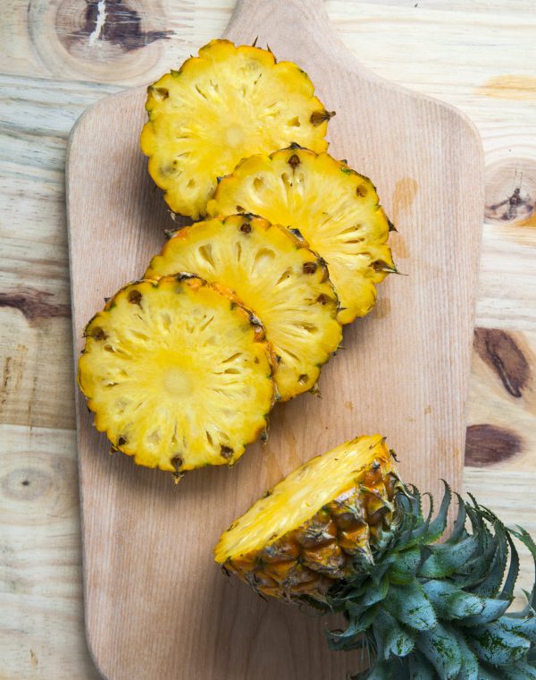 high-angle-view-pineapples-cutting-board-table